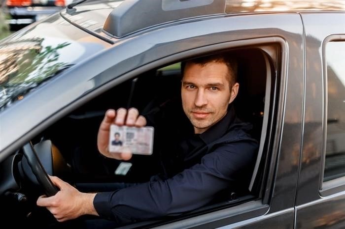 a-man-shows-a-driver-s-license-to-a-policeman-businessman-looking-at-the-camera.jpg